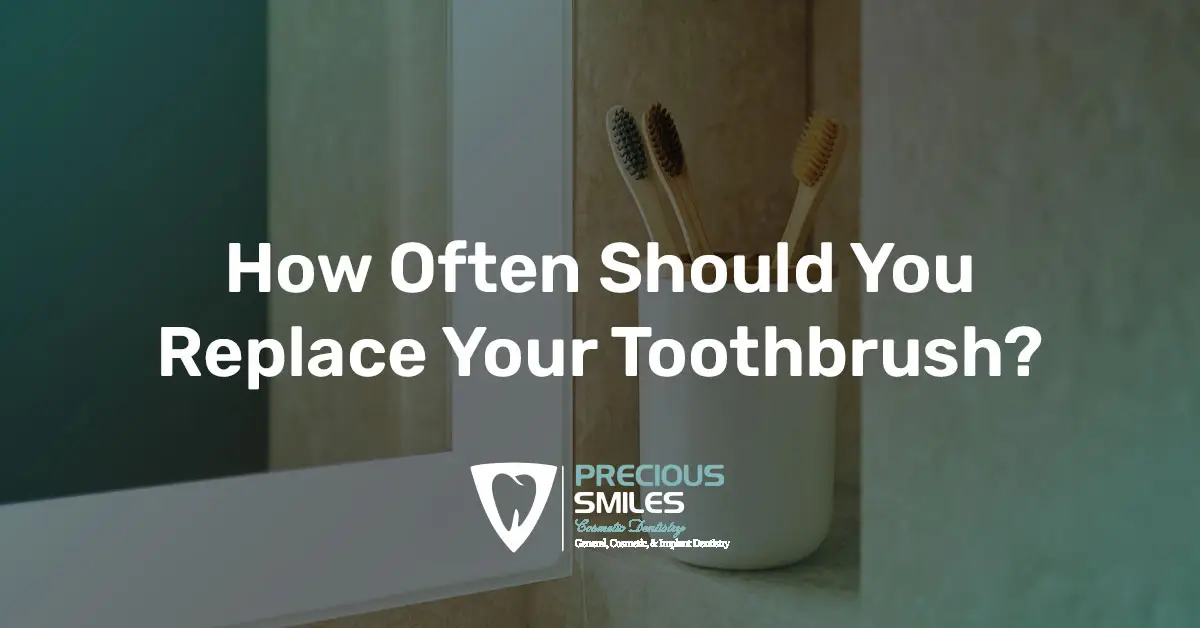Blog cover showing toothbrushes in a cup beside a mirror with the title 'How Often Should You Replace Your Toothbrush?'